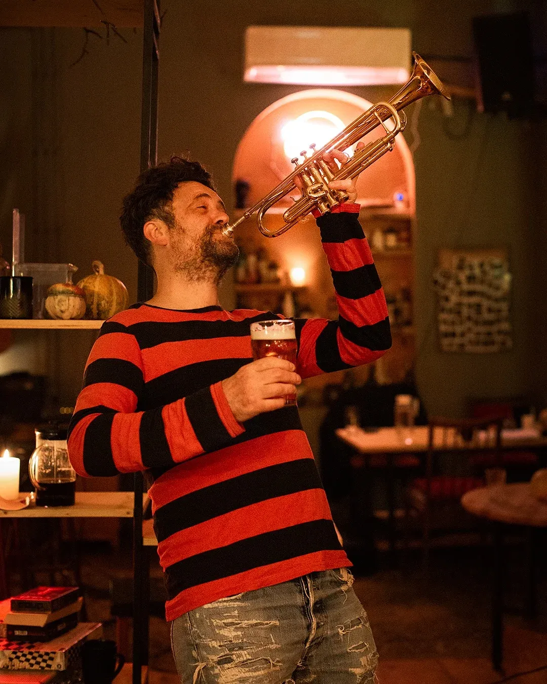A trumpet solo played one-handed, beer in the free hand